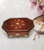 Elegant rosewood jewelry box with a detailed elephant inlay, embellished with gold chains and pearls, perfect for storage.