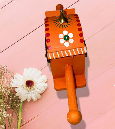 Handmade orange and white wooden palanquin toy with floral designs, showcasing Channapatna craftsmanship and Indian heritage.