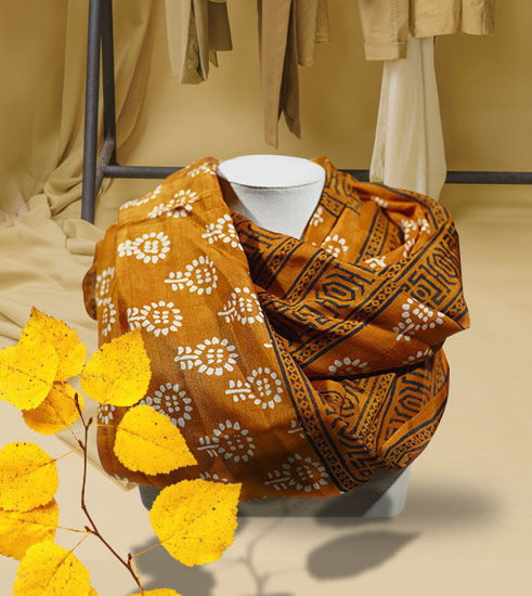 An orange silk scarf featuring vibrant geometric designs, showcasing ethnic Indian artistry and artisan craftsmanship.