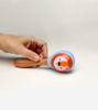 Handmade wooden rattle with a bear motif, safe for infants, featuring googly eyes and designed for easy gripping by tiny hands.
