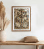 Traditional Bengal Patachitra art print framed on a wooden wall, featuring intricate wildlife scenes in earthy colors.