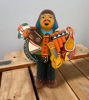 Ekeko doll figurine of a man with a musical instrument, representing the Tiwanakan god of abundance from Peru.