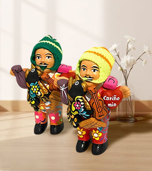 Two colorful ekeko dolls in vibrant clothes, showcasing traditional Peruvian craftsmanship and cultural symbolism of abundance.