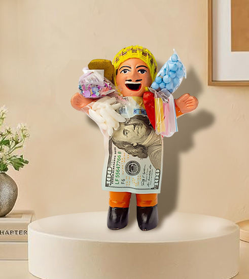 Handmade Ekeko doll, 5.5" tall, holding money and candy, symbolizing abundance and good luck in Andean culture.