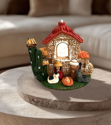 Handmade terracotta nativity scene figurine featuring a house, crafted by Peruvian artisans with intricate details.