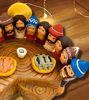 A wooden table featuring a handmade terracotta Last Supper scene with Jesus and his disciples, showcasing intricate details.