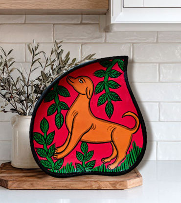 A hand-painted wooden tray features a joyful dog, showcasing vibrant Bengal Patachitra folk art.