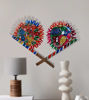 Colorful decorative fan with intricate bird motifs, handcrafted from wood, representing Indian folk art for display or gifting.