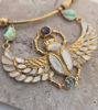 Unique scarab necklace with wings and gold pendant, showcasing golden pearl and abalone inlays, embodying ancient Egyptian symbolism.
