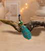 Vibrant peacock figurine with jeweled detailing on a white background, designed as a hinged keepsake box for jewelry storage.