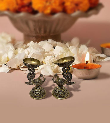 Traditional brass peacock oil lamps, set of 2, with detailed craftsmanship, perfect for rituals, decor, and festive occasions.
