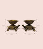 Pair of bronze tortoise diyas on a white surface, showcasing intricate craftsmanship for festive and puja decor.
